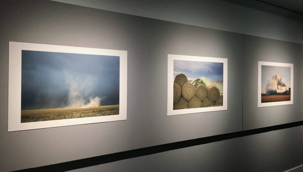 An image of three photographs on the gallery walls from the exhibition In the Air: A photographic investigation of the instances and processes that give rise to airborne particles